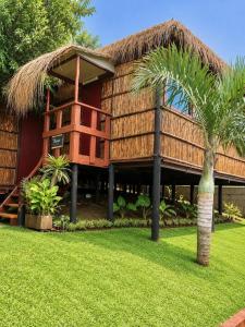 a resort with a palm tree in front of it at Moz Inn - Coconut View Resort in Lopes