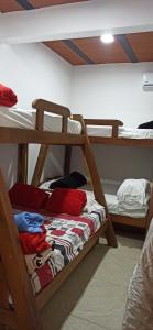 a room with two bunk beds with clothes on them at Atardeceres in Puerto Rey
