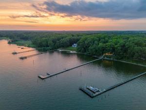 an aerial view of a lake with a dock at Scenic, Spacious Riverside Retreat Ropeyarn in Deltaville