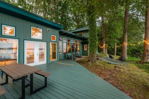 a house with a picnic table on a deck at Scenic, Spacious Riverside Retreat Ropeyarn in Deltaville +69 photos