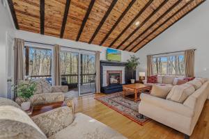 a living room with two couches and a fireplace at Ma-ple Haven --Wifi, Fireplace, Deck, Fire Pit, Family Friendly, Game Room, Pool Access in Berkeley Springs