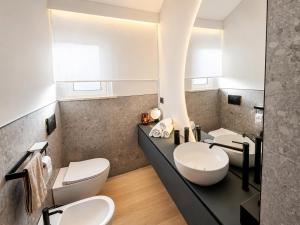 a bathroom with two toilets and a sink at Il borgo blu in Tortoreto Lido