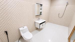 a bathroom with a toilet and a sink at Homestay Sadikin Scar Reef Beach Jelenga in Maluk