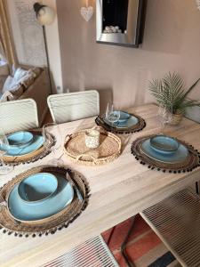 a wooden table with blue plates on top of it at Bavella in Zonza