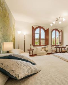 a bedroom with two beds and a living room at Tolaini Winery Suites in Castelnuovo Berardenga