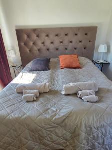 a large bed with two pillows and towels on it at 3A Centralt Boende i Dala-Floda! in Djuras
