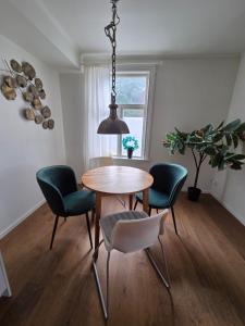 a dining room with a table and four chairs at 3A Centralt Boende i Dala-Floda! in Djuras