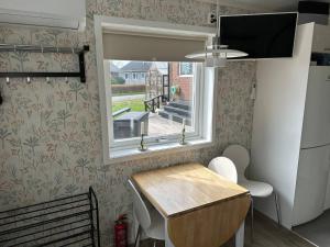 a small kitchen with a table and a window at Happy stay apartment in Vallda