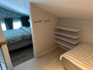 a bedroom with a bed and a closet with shelves at Happy stay apartment in Vallda