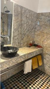 a bathroom with a sink and a counter with towels at La Maison Maure in Fez +84 photos