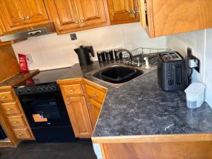 a kitchen with a sink and a counter top at Winnie baygo Meadow view in Hurst +16 photos