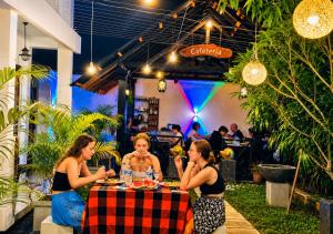 a group of women sitting at a table eating food at Ravan Safari Rest Inn in Udawalawe