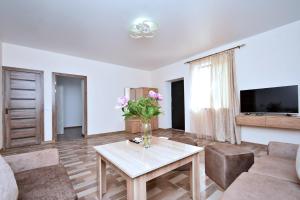 a living room with a vase of flowers on a table at Zvartnots International Hotel in Pʼarakʼar +19 photos
