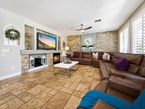 a living room with a couch and a fireplace at The Jade House Queen Creek in Queen Creek