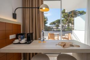 a kitchen with a table with a coffee maker on it at Cabot Cala Ferrera in Cala d´Or
