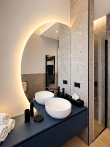a bathroom with two sinks and a mirror at Il borgo blu in Tortoreto Lido
