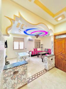 a living room with a table and a couch at Mhamid 4 in Marrakesh