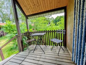 a porch with two chairs and a table on it at Radler-Pension in Lübbenau