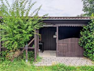 a brown building with a gate and a fence at Radler-Pension in Lübbenau +3 photos
