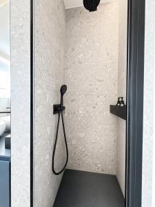a shower with a shower head in a bathroom at Il borgo blu in Tortoreto Lido +17 photos