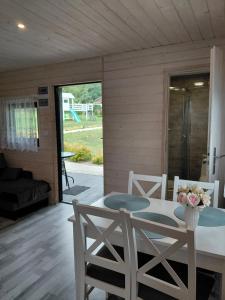 a dining room with a table and two chairs at Wichrowa Skarpa in Rusinowo