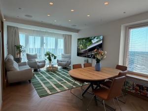 a living room with a table and chairs and a television at ViSky Ap in Visaginas