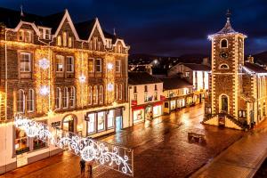 a city lit up at night with christmas lights at Inn on the Square in Keswick