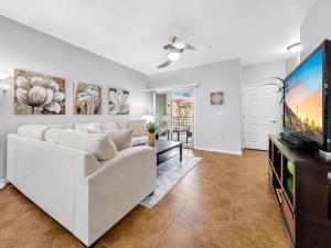 a living room with a white couch and a flat screen tv at Southern #1083 Mesa in Mesa