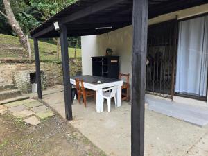 a table and chairs sitting under a pavilion at Tranquility PsJ in Port St. Johns