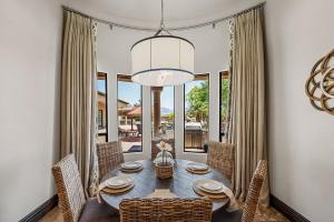 a dining room with a table and chairs and a large window at 104th Mesa 1331 Paradise Found in Mesa