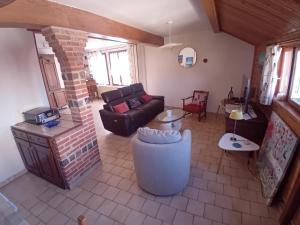 a living room with a couch and a fireplace at oiseau bleu in Dieppe