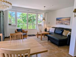 a living room with a couch and a table at Haus Wikinger in Born