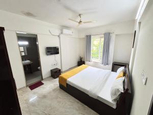 a bedroom with a large bed and a bathroom at Nestoria Corporate Services in Pune