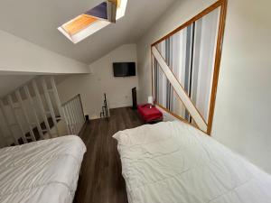 a bedroom with a bed and a large window at Duplex moderne & calme à Malakoff in Malakoff