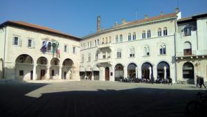a group of buildings with people standing in a courtyard at Apartment Irene in Pula