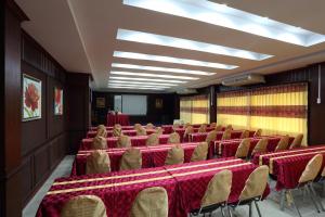 a room with rows of tables and chairs with red table cloth at Breezehill Khao Kho Hotel in Khao Kho +137 photos