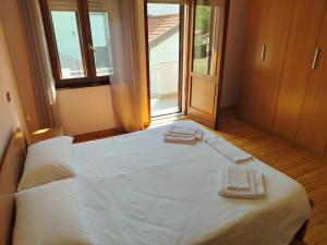 a bedroom with a bed with two towels on it at Piccola Stella in Moggio Udinese