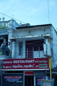 a building with a sign in front of it at Udhaya Lodge in Rāmeswaram +36 photos