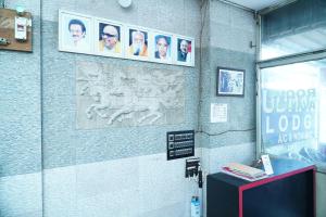 a wall with pictures of men on it at Udhaya Lodge in Rāmeswaram