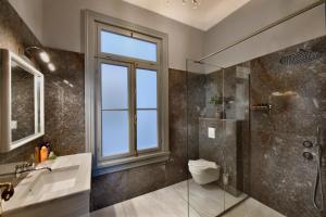 a bathroom with a shower and a toilet and a sink at Athenian Vintage Apartments in Athens