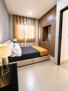 a bedroom with a king sized bed and a tv at Casa de la Paz in Colima