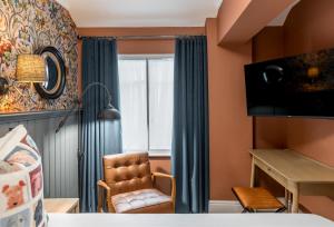 a room with a chair and a window at The Kings Arms Hotel in Keswick