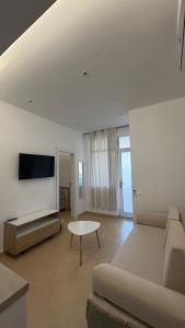 a living room with a couch and a table at Vila Gjoni in Sarandë