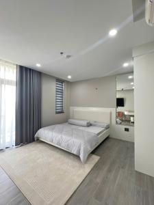 a bedroom with a large bed and a large rug at La Vida Residences Villa in Ấp Phước Thánh +17 photos