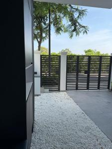 an open door to a patio with a tree at La Vida Residences Villa in Ấp Phước Thánh