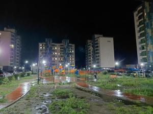 a city street at night with lights and buildings at Darkhan Apartment in Darhan