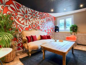 a living room with a couch and a table at ibis Quimper in Quimper