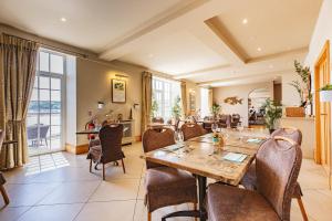 a dining room with a table and chairs at Braye Beach Hotel, Alderney in Alderney