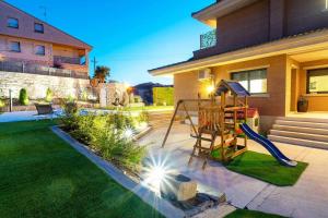 a backyard with a slide and a playground at La Cantera Rural Spa in Viñaixa