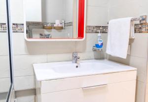 a bathroom with a white sink and a mirror at Apartamento moderno en Tanger in Tangier +22 photos